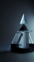 Modern glass crystal awards and trophies arranged on dark surface with dramatic lighting for corporate recognition and achievement ceremonies.
