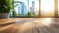 Sunlit wooden floor with blurred modern cityscape and houseplant through window, natural light creating warm atmosphere in contemporary interior space.