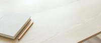 Blank notebook with wooden pencils on light wood desk surface, ready for writing, sketching, or creative work projects.