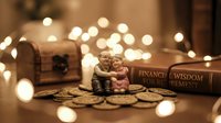Elderly couple figurine sitting on golden coins with warm bokeh lights creating cozy financial planning and retirement savings atmosphere for investment concepts.