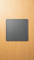 Gray square slate board on natural wood grain background for kitchen decor and food presentation displays.