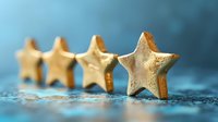 Golden star shaped cookies in row on blue textured background with selective focus and bokeh effect, festive holiday baking concept for celebrations.