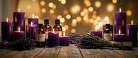 Lavender essential oil bottles with purple candles and dried lavender bundles on wooden surface with warm bokeh lights for aromatherapy and relaxation.