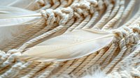 Delicate white feathers intertwined with natural rope knots create ethereal texture and pattern, evoking purity and organic design elements for spiritual or wellness themes.