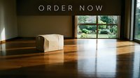 Cardboard box on shiny wooden floor in bright modern room with garden view and order now text overlay for e-commerce promotion.