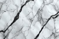Natural white marble texture with dramatic black veins creating an elegant pattern. Luxurious stone surface for interior design and architecture backgrounds.