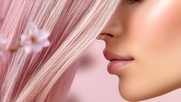 Close up profile view of feminine face with glossy pink lips and rose pink straight hair against soft pink background, beauty and cosmetics concept.
