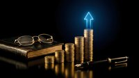 Financial growth concept with golden coins stacked in ascending order, glowing blue arrow pointing upward, vintage eyeglasses and pen on old book against dark background.