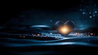 Glowing heart shape formed by light trails against dark blue background with bokeh effects and magical sparkles, creating romantic atmospheric scene.