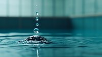 Mesmerizing water drops falling in sequence creating ripple effect on turquoise water surface with splash crown formation. Perfect for wellness and spa designs.