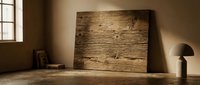 Rustic weathered wood plank panel leaning against warm beige wall in minimalist interior with natural sunlight streaming through window creating shadows.
