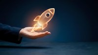 Hand holding glowing rocket icon against dark blue background, symbolizing startup launch, business growth, innovation and entrepreneurial success for corporate projects.