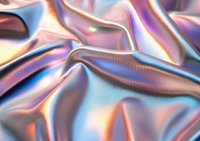 Holographic iridescent fabric with smooth waves and folds creating abstract pattern in pink, blue and purple metallic colors. Luxury textile background.