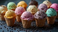 Colorful ice cream scoops in waffle cones arranged in row, featuring mint, strawberry, chocolate, vanilla flavors with sprinkles on dark background. Fresh dessert servings.
