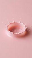 Liquid splash with crown-like formation and droplets on soft pink background, suitable for cosmetics, skincare, beauty product packaging, and wellness branding designs.
