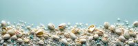Scattered seashells and pearls on turquoise background with copy space. Natural beach treasures arranged in border composition for summer design.