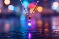 Glowing magical pendant necklace on chain with blue luminescent crystal reflecting on wet surface against blurred bokeh lights background in purple and orange tones.