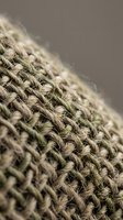 Close-up macro shot of natural jute rope texture showing detailed fiber weave pattern. Organic hemp cord material for crafting and industrial applications.