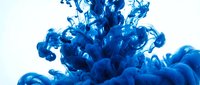 Vibrant blue ink swirling and dispersing in water, creating dynamic fluid patterns and abstract formations against white background for creative projects.