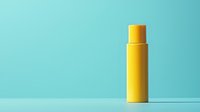 Yellow plastic bottle container on mint green background with shadow, minimalist product photography for cosmetic and personal care marketing.