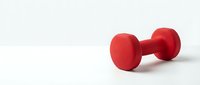 Pair of red dumbbells isolated on white background, ready for fitness and gym design projects, workout graphics, and health-related marketing materials.