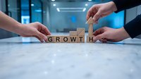 Business team building GROWTH word with wooden blocks on office table representing teamwork and company development strategy.