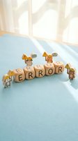 Wooden dice spelling error surrounded by tiny cartoon bears wearing yellow hard hats and warning signs on light blue surface with sunlight streaming through sheer curtains, representing mistake management and safety awareness.