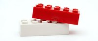 Red and white plastic building blocks stacked together on white background, isolated construction toy elements for creative play and educational activities.