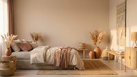 Cozy boho bedroom interior with neutral beige tones, pampas grass decor, woven textures and natural materials creating warm minimalist sleeping space.