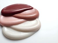 Cosmetic foundation makeup swatches in nude tones from light to dark showing skin color matching range for beauty products and skincare applications.