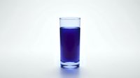 Glass of deep blue liquid isolated on white background, suitable for beverage, drink, health, wellness, and product mockup designs.