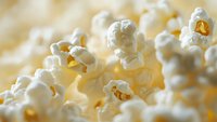 Fresh popcorn kernels close-up on warm yellow background showing fluffy white texture and golden centers, perfect for food and snack concepts.