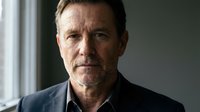 Middle-aged Caucasian man with facial hair wearing dark blazer and white shirt, serious expression, professional headshot for corporate, business, or executive use.