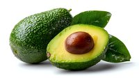 Fresh avocado cut in half showing pit and creamy flesh with whole avocado and green leaves on white background, isolated for food design.
