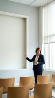 Professional businesswoman presenting in modern conference room with wooden chairs and large window for corporate meetings and business presentations.