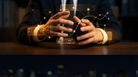 Businessman hands clasped on desk with glowing network connections overlay representing digital transformation and corporate strategy planning.