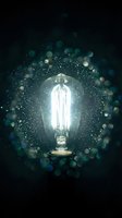 Glowing vintage Edison bulb surrounded by magical bokeh lights and sparkling particles on dark background for creative design projects.