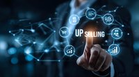 Businessman touching virtual upselling interface with digital icons showing sales strategy, marketing analytics, and customer relationship management tools.