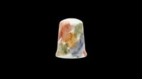 Ceramic sewing thimble with colorful watercolor paint splashes, isolated on transparent background, ready for clipart, stickers, print on demand, and t-shirt design use.