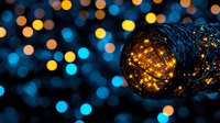 Glowing fairy lights in decorative wire mesh tube against blurred bokeh background creating magical atmosphere for festive celebrations and events.