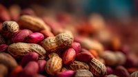 Mixed nuts and legumes pile with peanuts, almonds, and red beans creating colorful healthy snack arrangement for nutrition and cooking concepts.