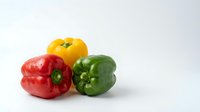 Colorful bell peppers in red, yellow, and green isolated on white background, ready for culinary, food, and design projects.