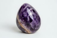 Polished amethyst crystal specimen displaying deep purple hues and natural banding patterns on white background, suitable for wellness and spiritual content.