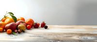 Fresh seasonal fruits arranged on rustic wooden table with copy space, bright natural lighting creates warm atmosphere for food photography.