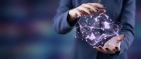 Businessperson holding glowing digital globe with network connections, representing global technology, data connectivity, and worldwide business innovation.