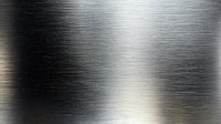 Brushed metal surface with horizontal scratched texture and light reflection creating industrial metallic background effect for design projects.