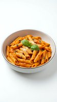 Penne pasta with tomato sauce, grated cheese, and fresh basil garnish served in a white bowl on isolated background for food photography and culinary design.