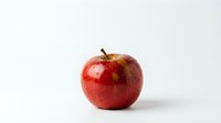 Fresh red apple with glossy skin isolated on white background for healthy eating concepts and food photography projects.