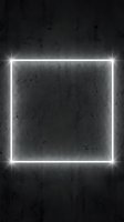 Neon square frame glowing white light on dark grunge concrete wall texture background. Modern urban design element for advertising and promotional content.
