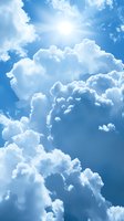 Dramatic white cumulus clouds against vibrant blue sky with sunlight breaking through, creating ethereal atmosphere and natural lighting effects.